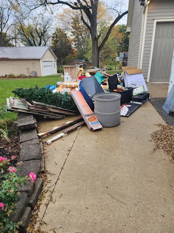 Dumpster being loaded with debris for Estate Cleanout Dumpster Rental in Valrico